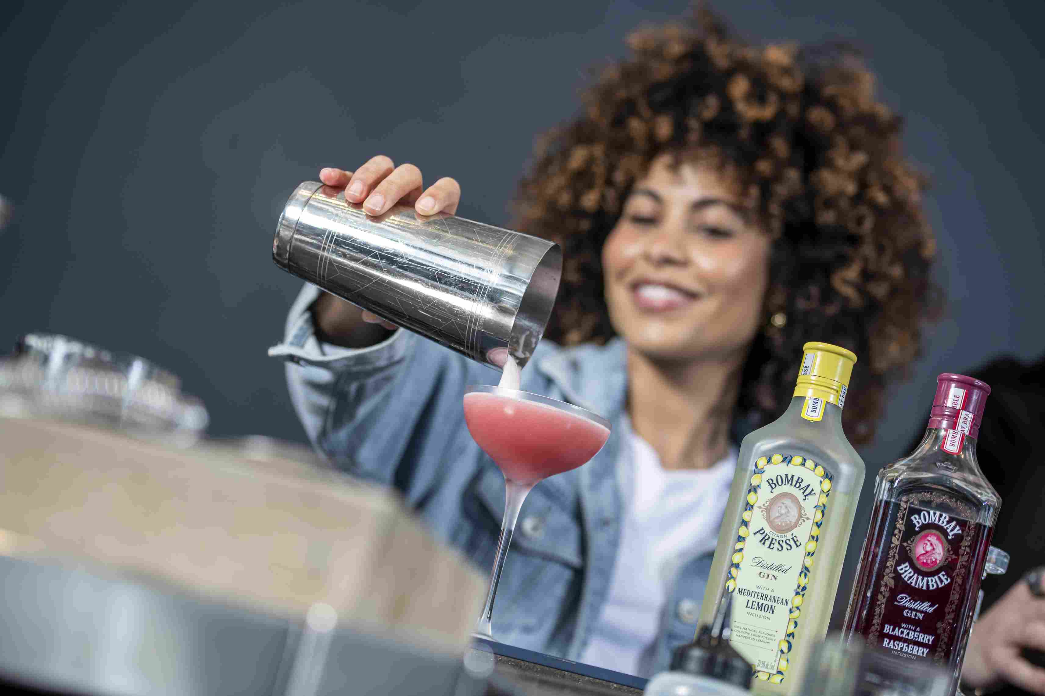 woman making cocktail